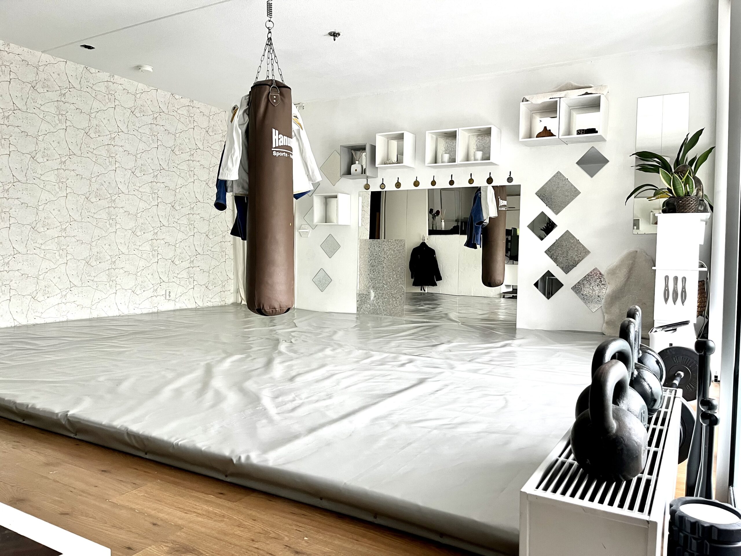 Dojo with boxing sack and matted floor