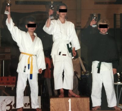 20210808_095916731_iOS (1)555 I am not new to beating boys. I used to kick ass at the playground. After that I would take the first place on the podium before more experienced boys in judo tournaments all over the country. In high school I would emberass my male classmates, taking down one after another in arm wrestling matches during the breaks. That is me in the picture, with my white belt, age 11. Mwaha.